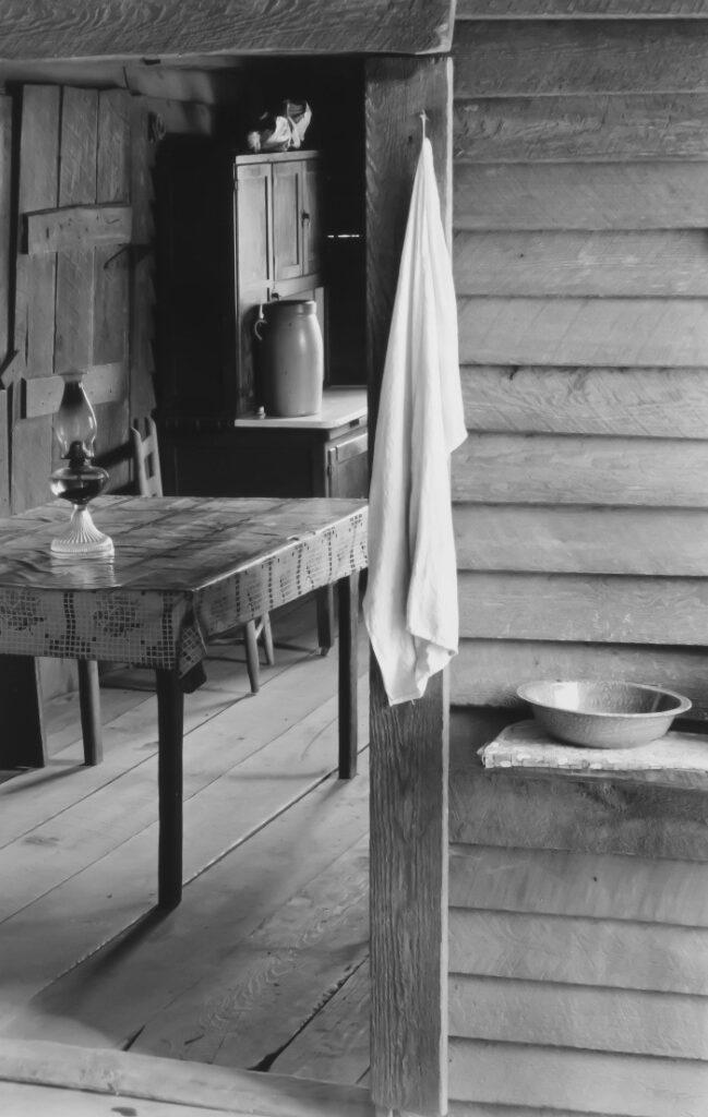 walker-evans-Part-of-the-kitchen-Home-of-sharecropper-Floyd-Burroughs-showing-washstand-in-the-dog-run-and-view-into-the-kitchen